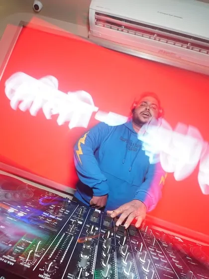 A cool long-exposure shot with red light trails, capturing the motion and energy of a live set.