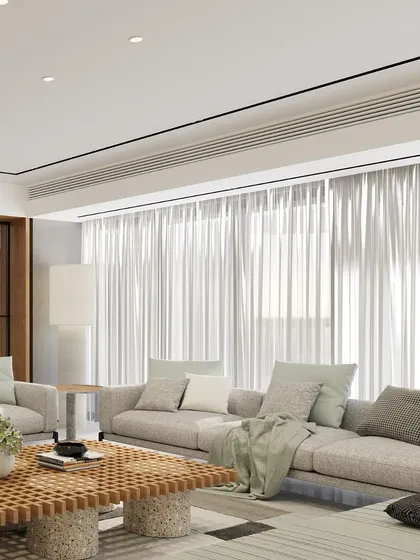 Elegance lies in simplicity. This living room features nude-colored upholstery and a checkered timber coffee table, creating a refined design that is upscale yet comfortable. The space perfectly blends sophistication with a warm, homely ambiance.