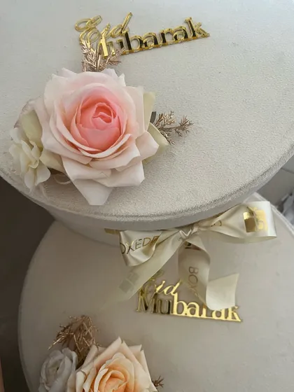 The elegant exterior of my velvet Eid gift boxes, adorned with a delicate rose and a golden "Eid Mubarak" acrylic cutout.