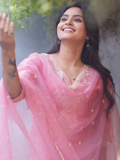 A joyful and expressive shot, capturing a moment of pure happiness. The makeup is light and enhances her natural radiance.