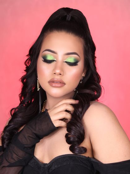 Get ready to dazzle with this green glittery eye makeup. This look combines a dark smokey base with a pop of bright green glitter for a mesmerizing effect.