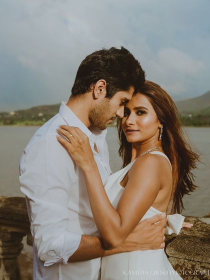 A beautiful close-up portrait where the woman connects with the camera while being held by her partner. This style of shot is both intimate and engaging.