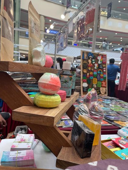 My stall setup at EA Mall in Chennai, with a wooden stand displaying bath bombs and various soaps.