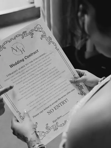 "Sign here if you dare!" A playful, custom-made "wedding contract" for guests to sign, adding a dose of humor to the entry.