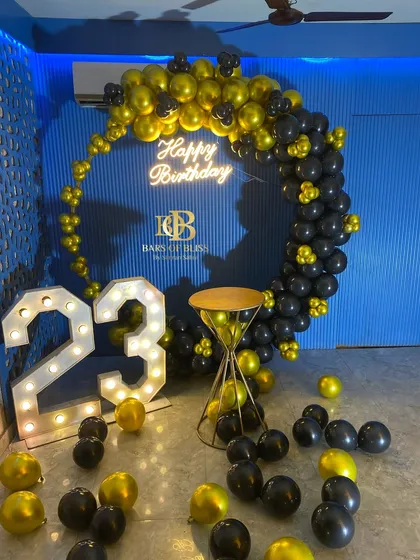 Another angle of the striking black, yellow, and blue decor for a 23rd birthday. This view shows the full impact of the color combination and the placement of the decor elements in the space.
