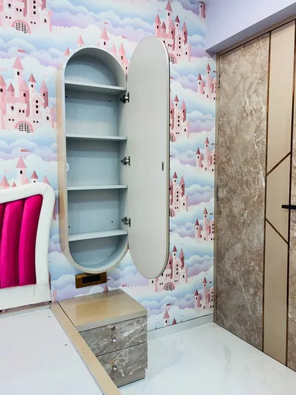 A floating dressing table in a kids' room with a unique oval mirror cabinet that opens to reveal hidden shelving.