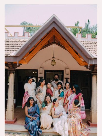 A beautiful group photograph of the bride and groom with their family and friends, a memory to be treasured.
