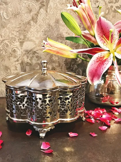 This ornate silver filigree box is a piece we created for a wedding client. Its classic design and detailed craftsmanship make it a luxurious favour that guests can use and admire in their homes, reminding them of the special day.