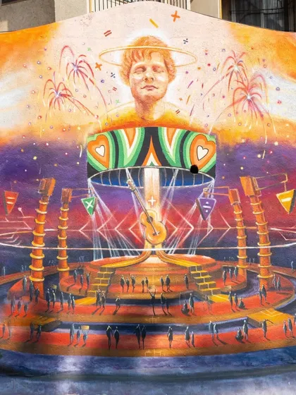 A fantastical mural created in Bandra to announce Ed Sheeran's concert in Mumbai. The artwork depicts the artist on a vibrant, futuristic stage, capturing the energy of a live music event.