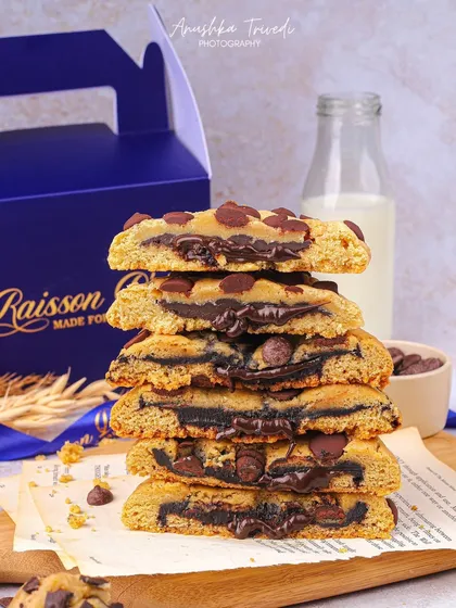 A stack of chocolate chip cookies sliced in half to show the gooey, melted chocolate inside. This is a classic shot that always drives cravings.