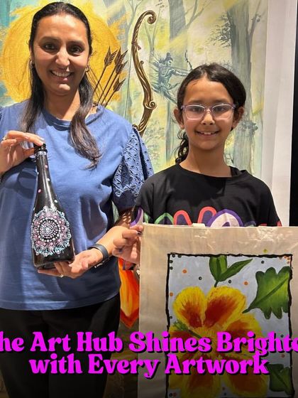 The Art Hub shines brighter with every artwork created. A mother and daughter duo proudly display their finished pieces: a hand-painted bottle and a vibrant floral tote bag.