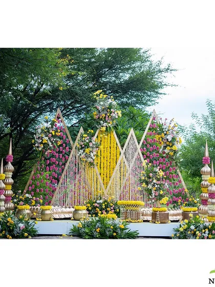 The Mangalasnanam ceremony deserves a setting that is both beautiful and serene. This pastel-themed decor features geometric backdrops adorned with delicate floral arrangements and traditional brass pots, offering a fresh and elegant take on a cherished ritual.