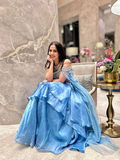 A princess moment in a dreamy, layered blue gown. This look is perfect for a fairytale-themed reception or engagement party.