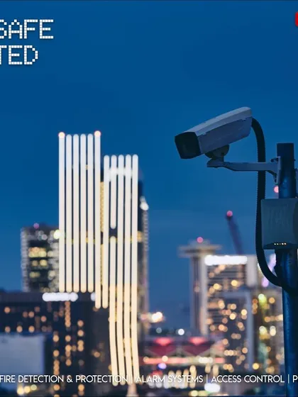 Our smart city solutions help keep communities safe after dark. A surveillance camera overlooks a city skyline at night, representing our role in providing 24/7 monitoring for urban environments.