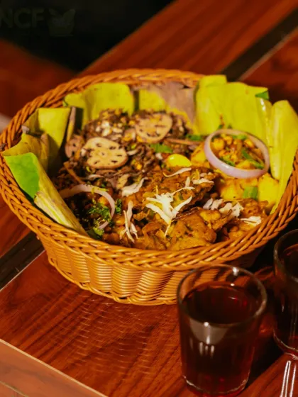 Our snack basket lined with banana leaves, filled with singju and bora, and served with two glasses of hot black tea.