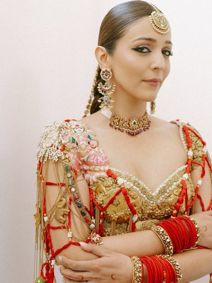 A powerful and poised portrait. This shot highlights the sharp, winged kohl-rimmed eyes and the warm, sculpted cheekbones of the "Modern Maharani" look.