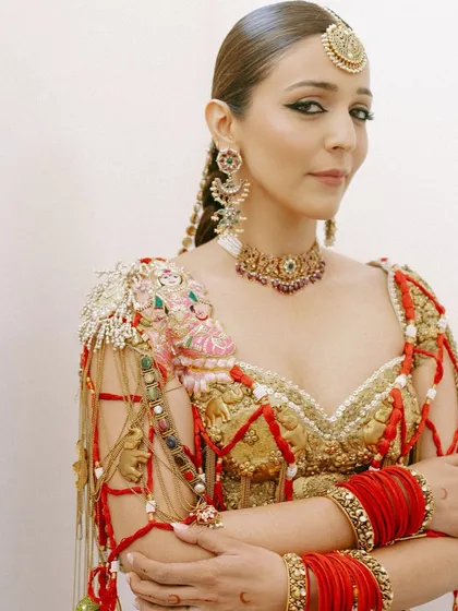 A powerful and poised portrait. This shot highlights the sharp, winged kohl-rimmed eyes and the warm, sculpted cheekbones of the "Modern Maharani" look.
