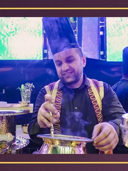 Our maestros, skilled and dedicated, craft culinary masterpieces that leave a lasting impression. This chef is preparing a traditional Indian dish in a brass pot, showcasing our commitment to authenticity.