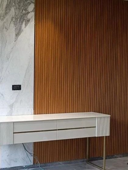 A view of the white console against a fluted wood wall panel, showing how we use contrasting textures to create a rich and layered interior.