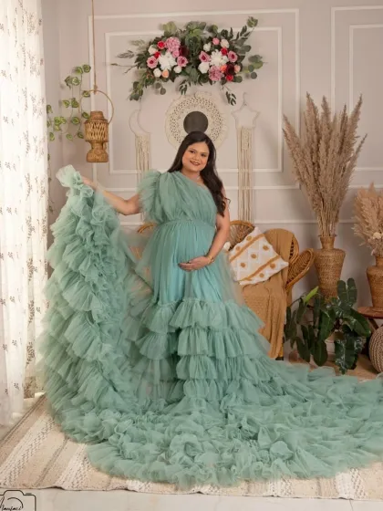 The flowing mint green gown looks absolutely stunning in this full-length portrait, showcasing its beautiful ruffles and movement.