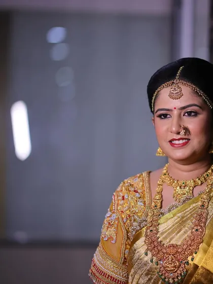 A candid moment of Rashmi on her wedding day. Her smile and glowing makeup reflect the happiness of the occasion.