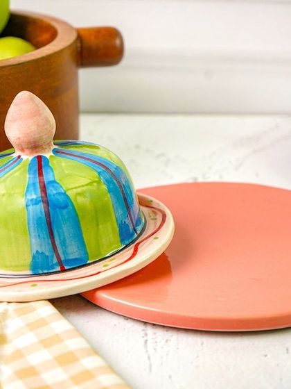The butter dish styled on a kitchen counter, with the lid slightly ajar. This small detail makes the scene feel more natural and lived-in.