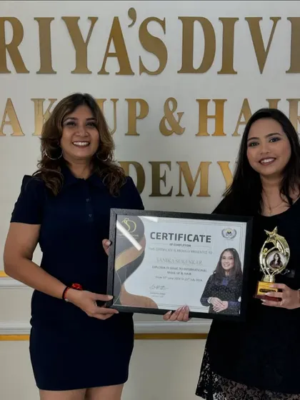 A proud graduate receiving her certificate and trophy. This marks the beginning of her professional career.