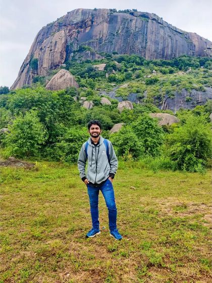 Standing before the magnificent rock face of Achalu Betta. It's an impressive sight and a great spot for photos.