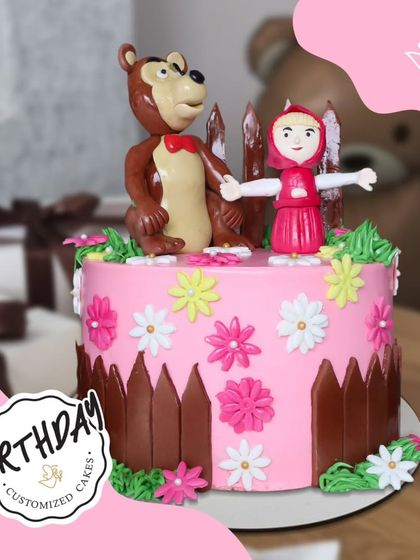 A sweet Masha and the Bear cake, featuring the adorable duo in a field of flowers. This charming design is perfect for fans of the heartwarming animated series.