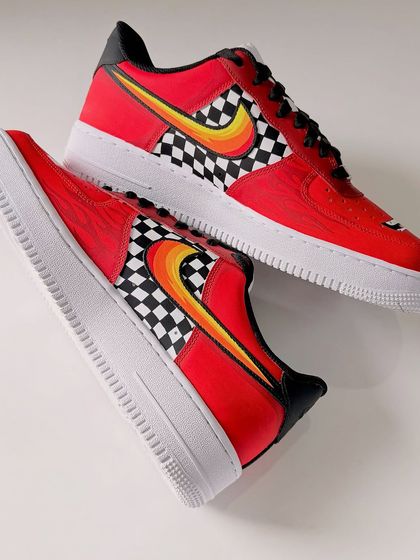 "Cars" movie-inspired Air Force 1s for a couple. This red pair is designed to look like Lightning McQueen, with his signature number 95 and racing flames.