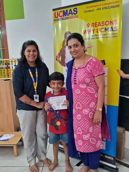 A proud moment for a student and his parent at the Abacus certification event.