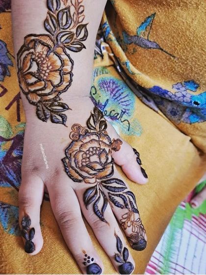 The same floral design as the previous image, but showing the rich, dark stain after the henna paste has been removed. We also teach you how to mix henna for the best possible color results.