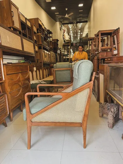 Another view of the high-back lounge chair, showing its profile and the surrounding furniture in my store.