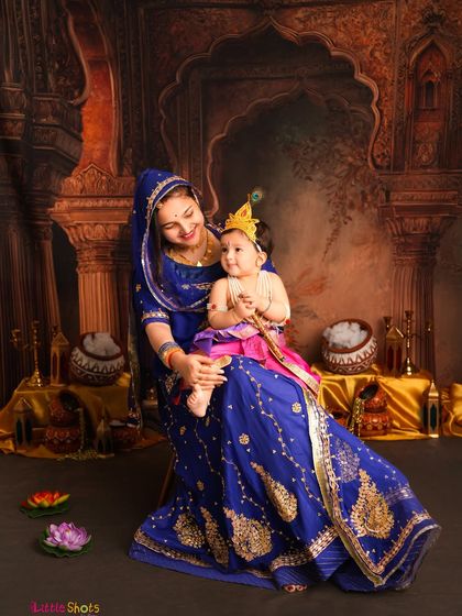 A mother dressed as Yashoda with her little Krishna. The composition and traditional props, like the pot of butter, add wonderful storytelling elements to the photo.