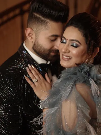 A romantic close-up of this lovely couple. The bride's smokey blue glitter eyeshadow was designed to match the details on her gown.