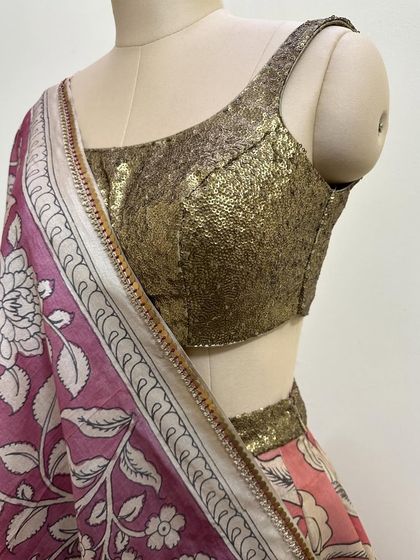 A detailed shot of the gold sequin blouse, a versatile piece that can be paired with various sarees and lehengas.