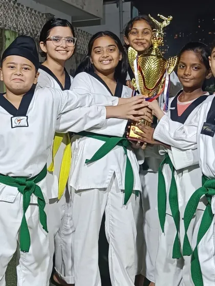Our older students and team captains proudly display the team trophy. They are role models for the younger warriors in the dojang.