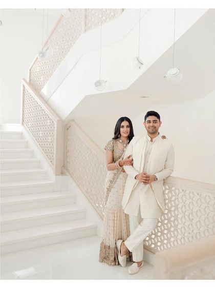 A stylish couple posing on a pristine white staircase. This portrait is clean, modern, and elegant, showcasing the couple's impeccable taste and my eye for architectural composition.