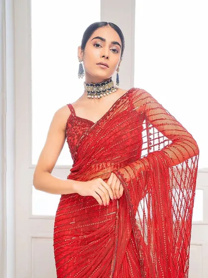 For this fashion shoot, I created a sleek, center-parted low bun. This hairstyle is elegant and clean, drawing all attention to the model's face and the stunning red saree.