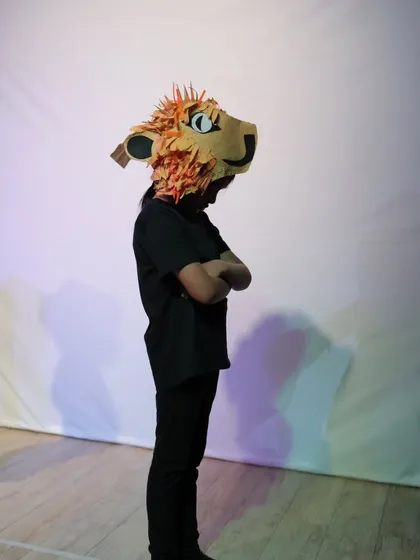 A student wearing the magnificent, handcrafted lion mask for our Narnia-inspired production.