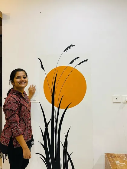 A minimal and modern wall painting for a hall entrance. The simple silhouette of grass against a warm setting sun creates a calming, boho vibe that is both stylish and serene.