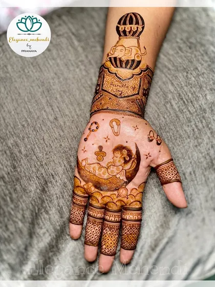 Celebrating a new life is so special. This baby shower mehendi design features a sweet baby sleeping on the moon, with a hot air balloon and other cute elements to welcome the little one.