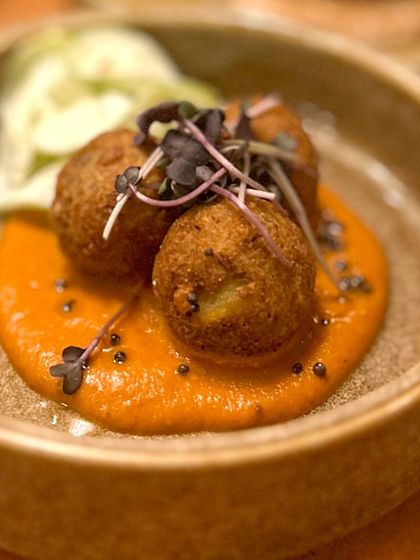 A delicious bite from our Hosa pop-up. These crispy fried bites are served on a flavorful sauce, showcasing the kind of creative small plates we love to feature.