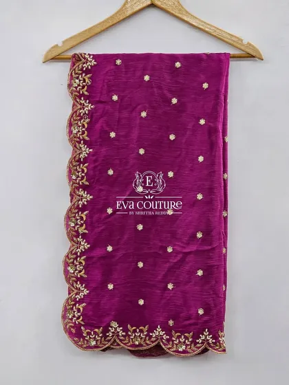A magenta dupatta or half-saree with a scalloped, embroidered gold border. This can be paired with a lehenga to create a beautiful half-saree look.