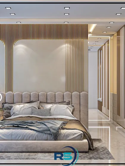 A bright and airy bedroom design with a comfortable upholstered bed and a built-in window seat. The combination of wood paneling and light-colored walls creates a warm and inviting space.