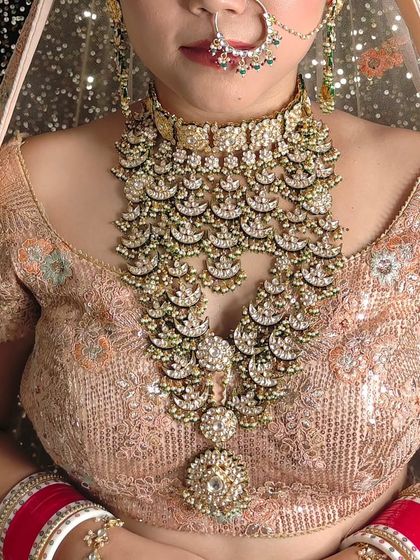 A magnificent and heavy layered necklace with a chandbali design. This is a true showstopper piece for a grand bridal entry.
