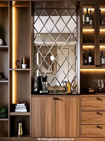 I designed this elegant bar and crockery unit to be a statement piece. It features a mix of wood cabinetry, glass-fronted shelves with internal lighting, and a mirrored backsplash to add depth and sophistication to the dining area.