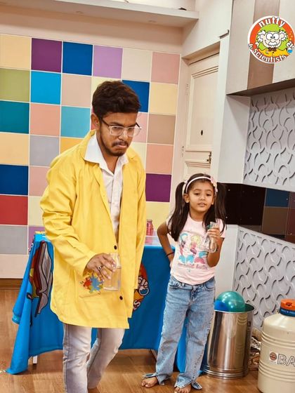 A young scientist gets one-on-one guidance from a professor. We foster a supportive environment where kids feel comfortable asking questions and exploring.