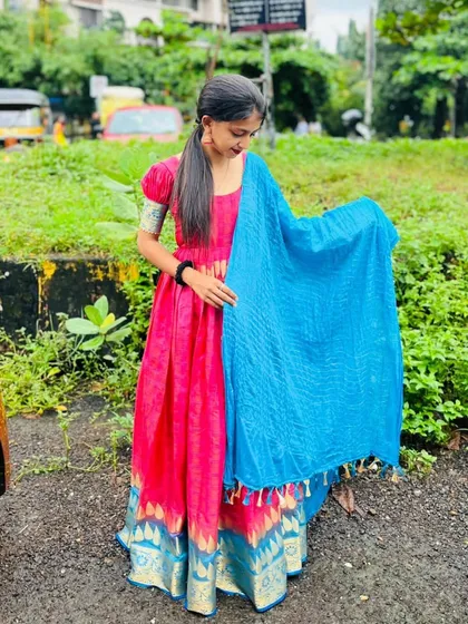This is one of my favorite projects where I turned a client's old saree into a brand new dress. This vibrant pink anarkali-style gown keeps the beautiful border of the original saree, giving it a fresh and modern life.