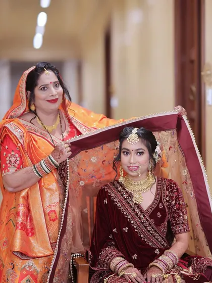 A touching moment as the bride's mother adjusts her veil before the wedding ceremony.
